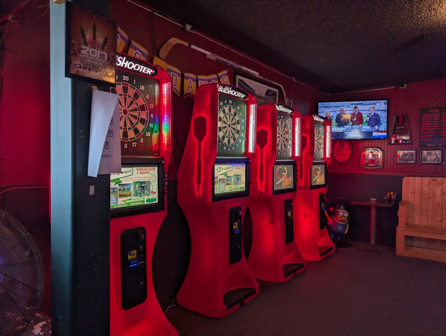 BullShooter electronic dart boards in the red-lit dart room